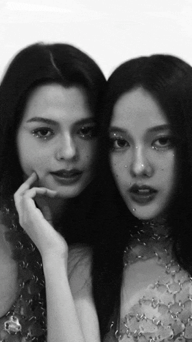 two women are standing next to each other and one has rhinestones on her nose