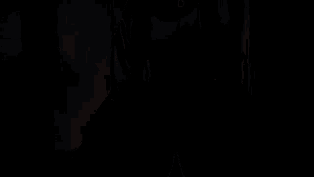 a person 's feet are shown in a dark room with a few drops of water on the floor