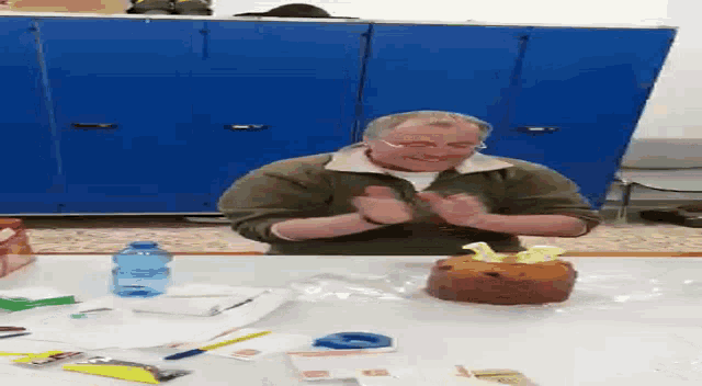 a man is sitting at a table with a bottle of aquafina water in front of him