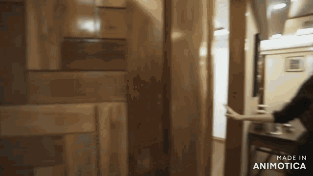 a woman is opening a wooden door with the words made in animotica below her