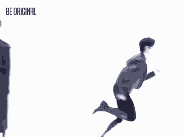 a man in a suit is kicking a ball with the words be original behind him