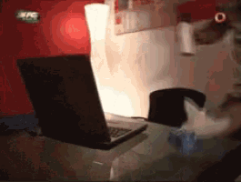 a laptop sits on a desk in front of a lamp and a sign that says kfc