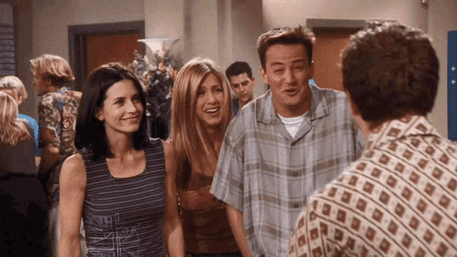 a man in a plaid shirt is talking to a woman in a striped top