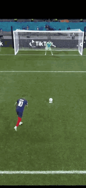 a soccer player wearing a blue jersey with the number 10 on the back