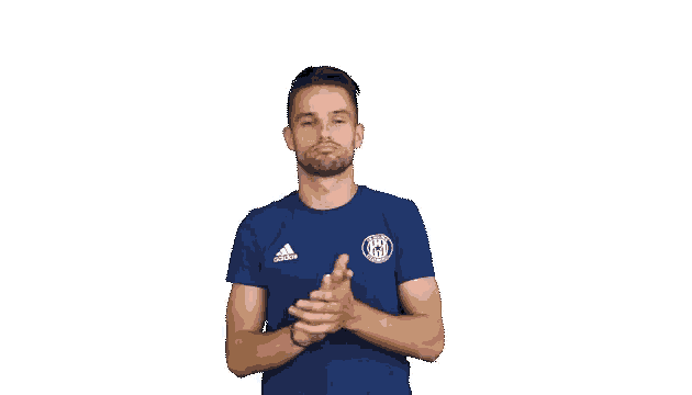 a man wearing a blue adidas shirt applauds