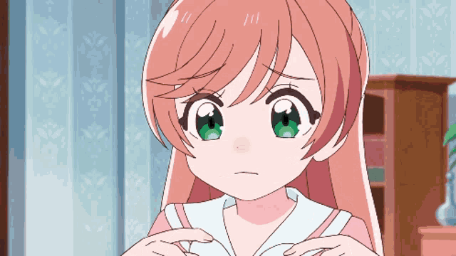 a girl with long pink hair and green eyes looks sad
