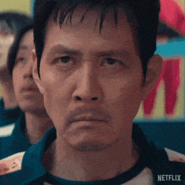 a close up of a man 's face with a netflix logo on the bottom right