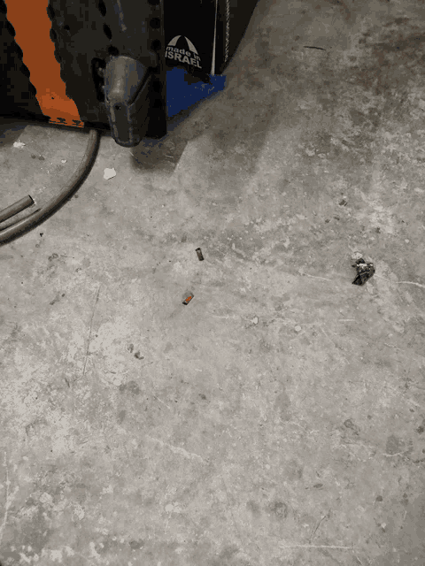 a dirty concrete floor with a box that says israel on it