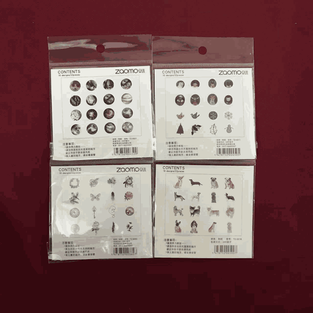 four packets of zoomo stickers are lined up on a red surface