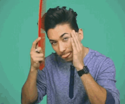 a man in a purple shirt is holding a red object