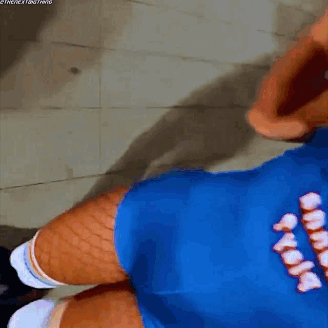 a person wearing a blue shirt that says ' smack ' on it