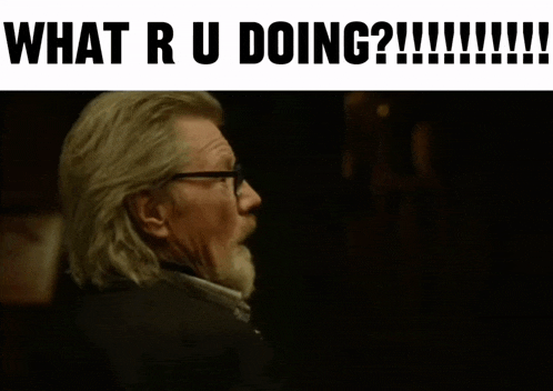 a man with glasses and a beard is being asked what he is doing