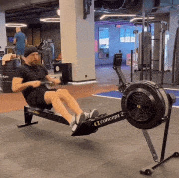 a man is rowing on a concept 2 machine in a gym