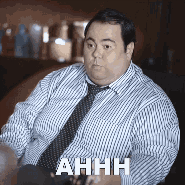 a man in a striped shirt and tie says ahhh in white letters