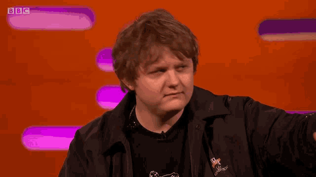 a man with a bbc logo on the bottom right of his screen