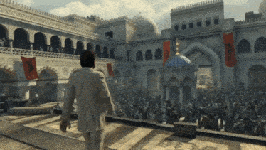 a man in a suit is walking in front of a crowd of people