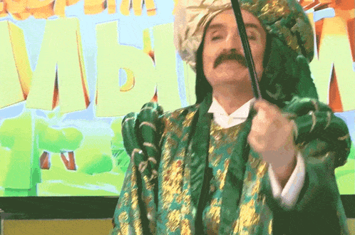 a man in a green and gold outfit holds a sword