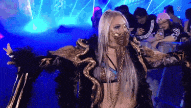 a woman wearing a mask is standing in front of a crowd of people