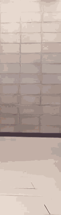 a blurry picture of a person walking on a white floor .