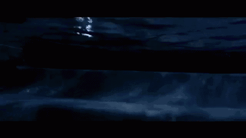a blurred image of a person swimming in the water at night