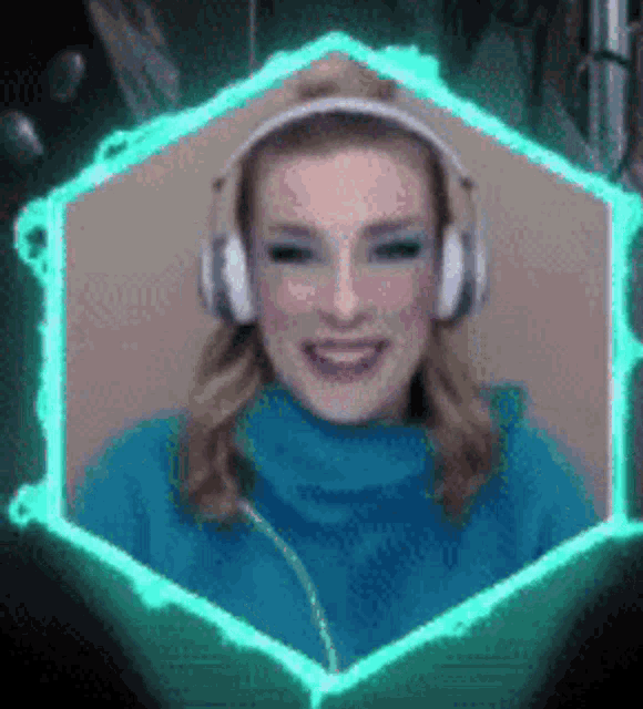 a woman wearing headphones and a blue sweater is smiling in a hexagon frame .
