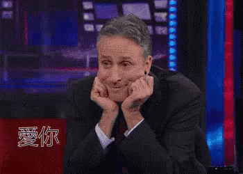 a man in a suit and tie has heart shaped eyes on his face
