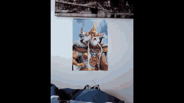 a painting of a man with horns and a beard is on a wall