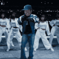 a man wearing a blue hat is dancing with a group of women
