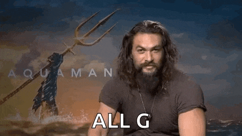 a man with long hair and a beard is giving a thumbs up sign .