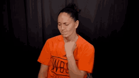 a woman wearing an orange shirt that says wbm