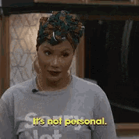 a woman wearing a gray shirt that says sorry not personal