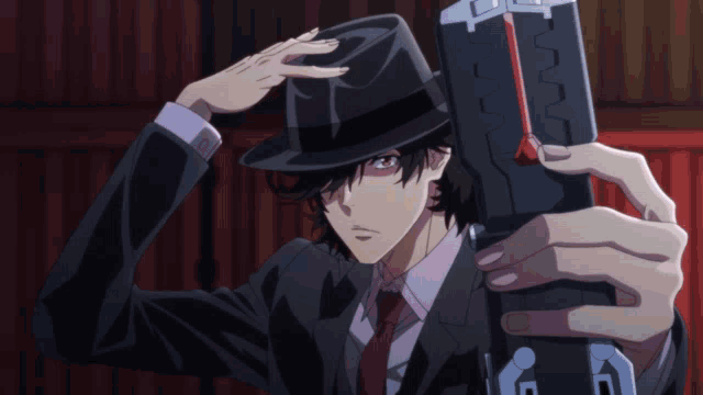 a man in a suit and hat is holding a gun that says ' g ' on it