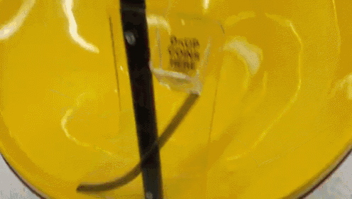 a person is putting a coin in a drop coins here machine