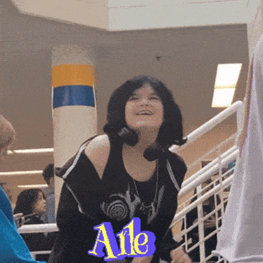 a girl wearing headphones stands in front of a sign that says ' ale '