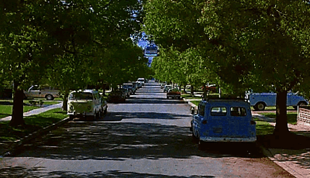 a blue van is parked on the side of the road in a residential neighborhood