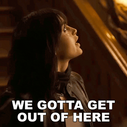 a woman in a leather jacket is standing on a set of stairs and says we gotta get out of here .