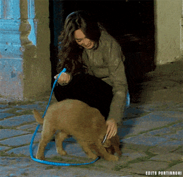 a woman playing with a puppy on a leash with edits portirroni written on the bottom