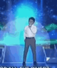 a man singing into a microphone on a stage with the words " all the power " on the bottom