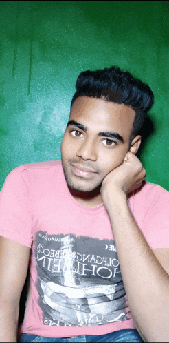 a man wearing a pink t-shirt that says johnny on it