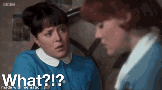 a woman in a blue shirt is talking to another woman in a white collared shirt with the words " what ? " below her