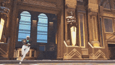 a woman stands in front of a building with statues