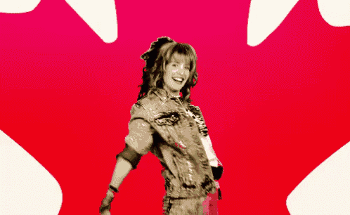a woman standing in front of a red maple leaf