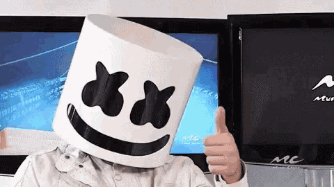 a person wearing a marshmello hat giving a thumbs up