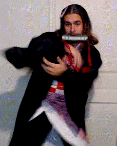 a man in a black coat is holding a harmonica
