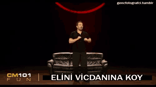 a man standing in front of a couch with cm101 fun written on the bottom right