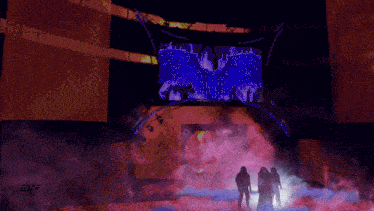 a group of people standing in front of a stage with a sign that says elyr