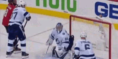 a hockey game is being played in front of an advertisement for hulu and gatorade