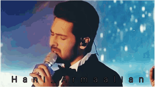 a man in a tuxedo is singing into a microphone with the name hani armalian written on the bottom
