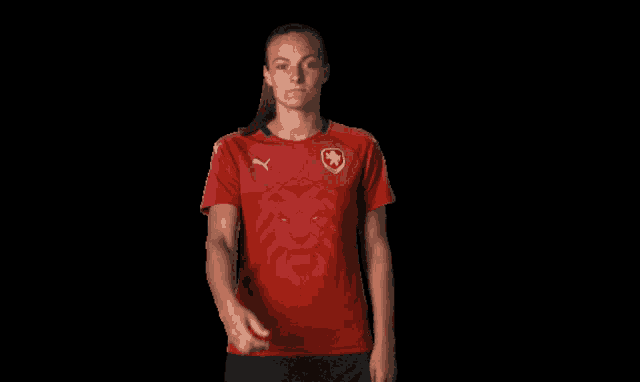 a woman in a red puma shirt with a lion on it