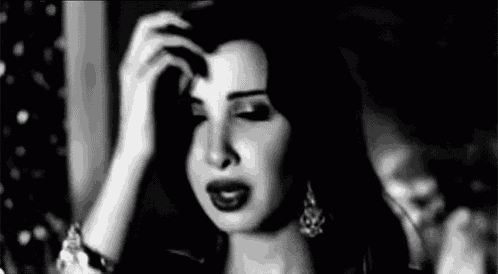 a black and white photo of a woman scratching her head .